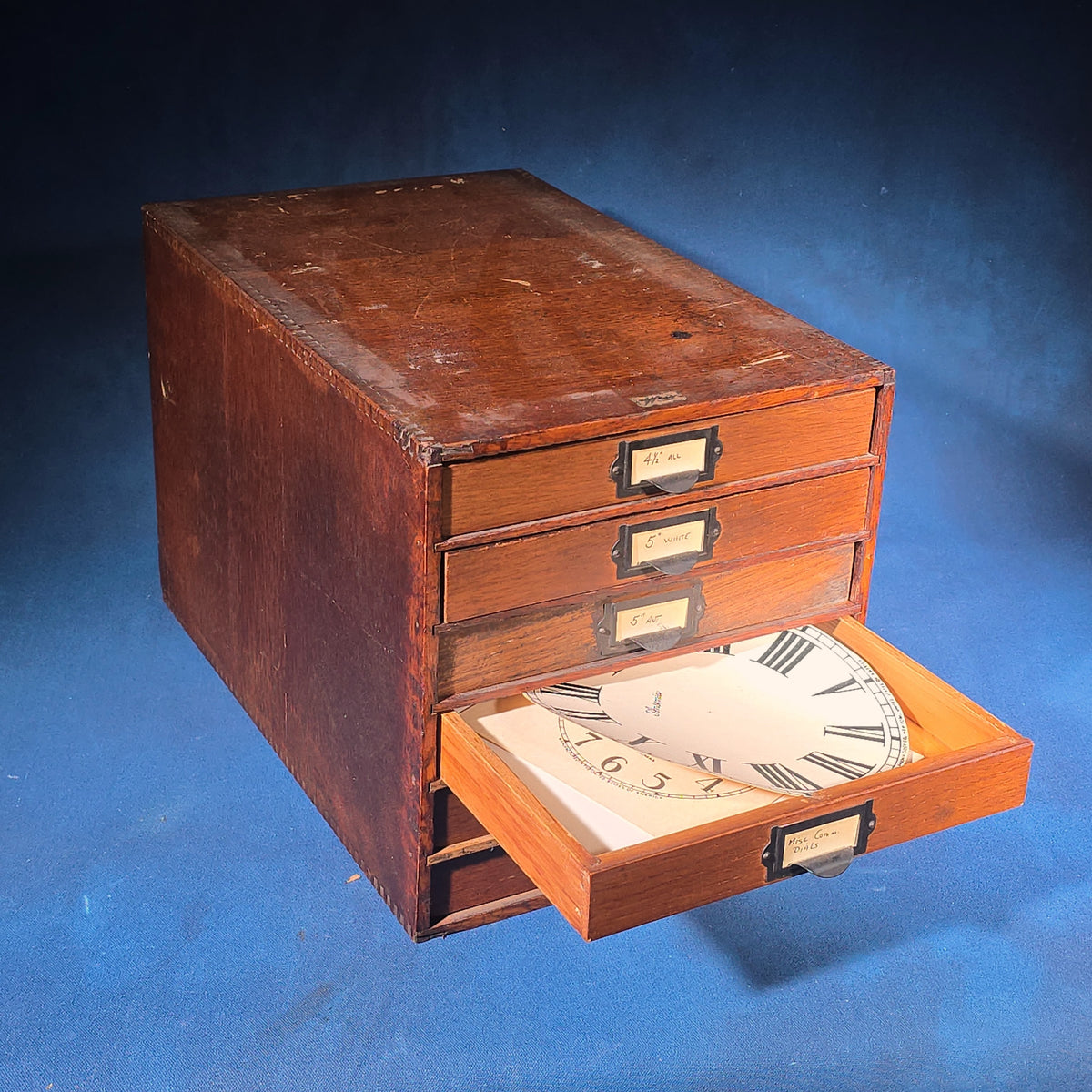 Vintage Oak Five-Drawer Cabinet with Clock Repair Paper Dial Faces including Ansonia, Sessions, and Ingraham