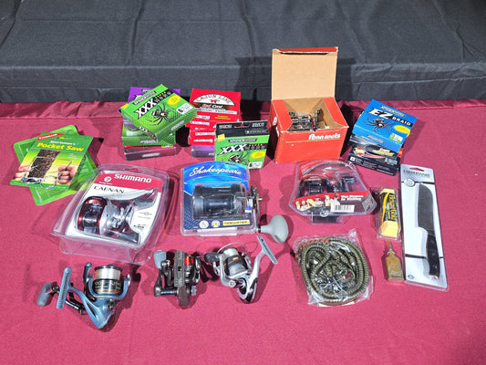 Grouping of Modern Fishing Reels, Line, and Tackle including Shimano Caenan 100, Shakespeare Tidewater, Quantum, and Penn Reels