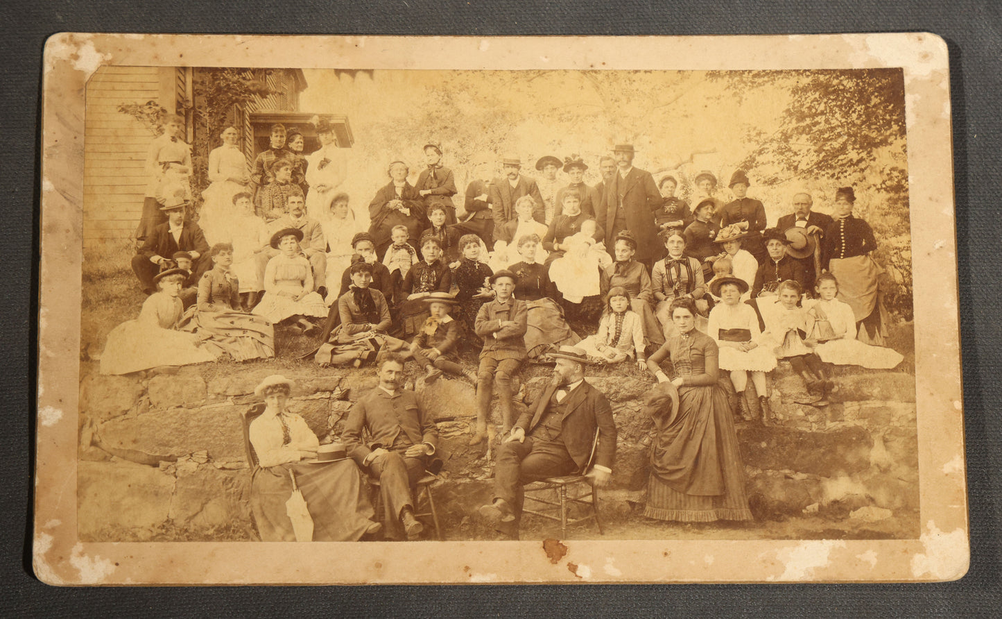 Grouping of Seven Antique Board-Mounted Photographs Including a Church, Street Scene, Couple's Portrait, Family Gathering, School Group, Early Automobile, and Parlor Interior with Telephone