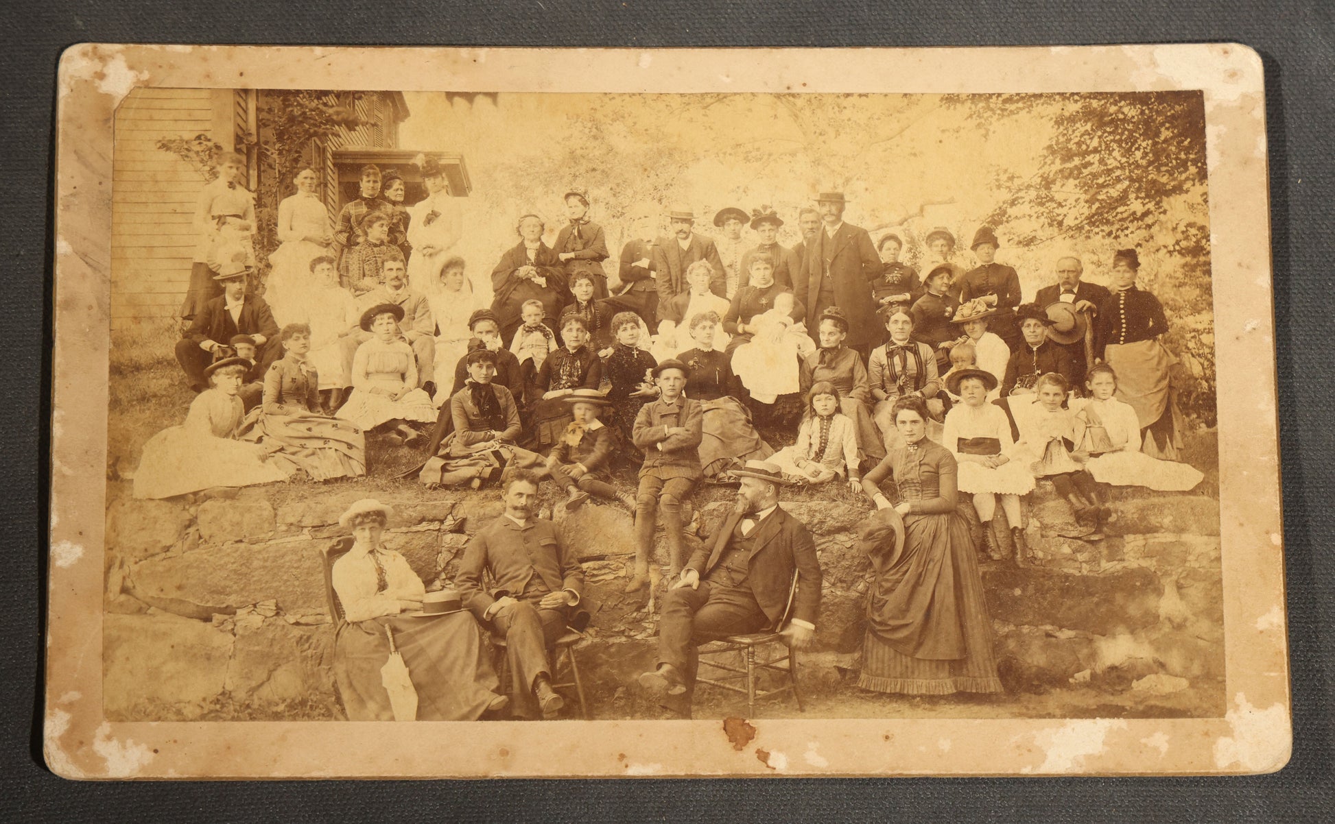 Grouping of Seven Antique Board-Mounted Photographs Including a Church, Street Scene, Couple's Portrait, Family Gathering, School Group, Early Automobile, and Parlor Interior with Telephone