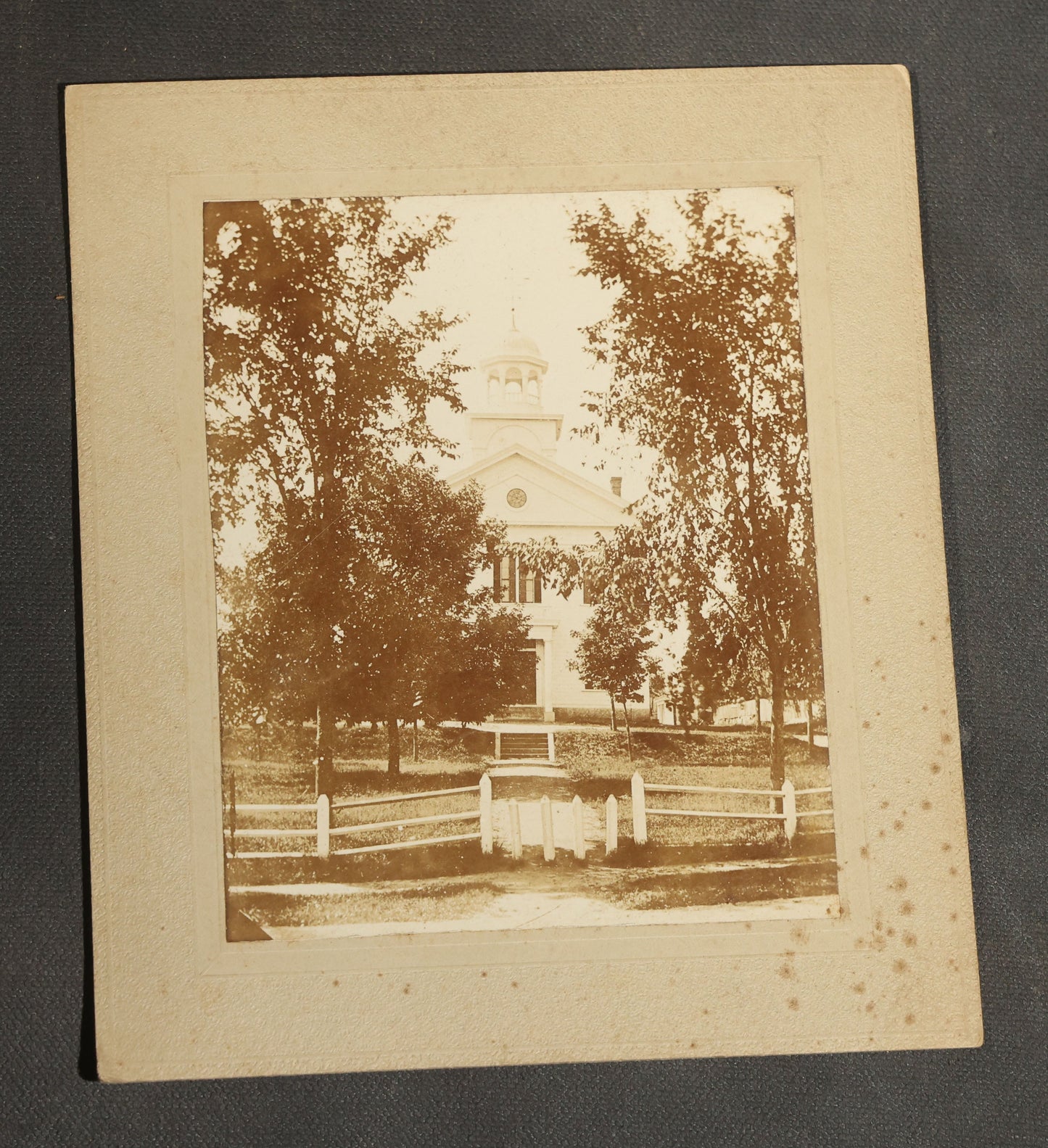 Grouping of Seven Antique Board-Mounted Photographs Including a Church, Street Scene, Couple's Portrait, Family Gathering, School Group, Early Automobile, and Parlor Interior with Telephone