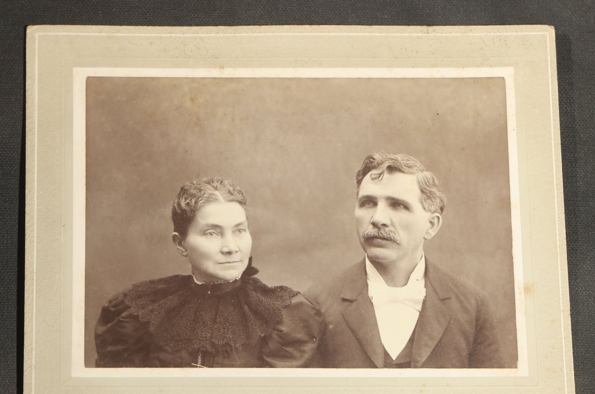 Grouping of Seven Antique Board-Mounted Photographs Including a Church, Street Scene, Couple's Portrait, Family Gathering, School Group, Early Automobile, and Parlor Interior with Telephone
