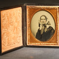 Lot 118 - Antique 1/9th Plate Ambrotype Photograph of a Middle-Aged Woman in a Bonnet and Dark Dress, Full Intact Leatherette Case