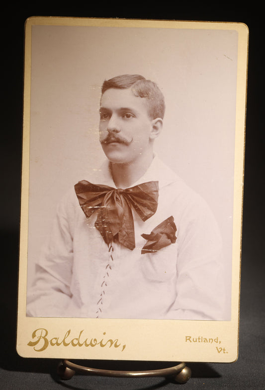 Antique Cabinet Card Photograph of a Man in a Laced White Shirt with a Large Bow, Possible Performer, Photographed by A.A. Baldwin, Rutland, Vermont