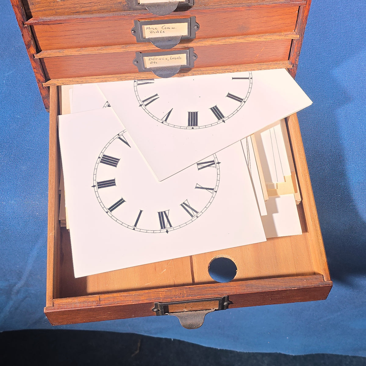 Vintage Oak Five-Drawer Cabinet with Clock Repair Paper Dial Faces including Ansonia, Sessions, and Ingraham
