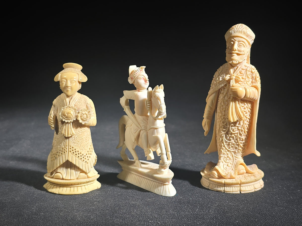Trio of Antique Carved Ivory Chess Pieces including King, Queen, and Knight