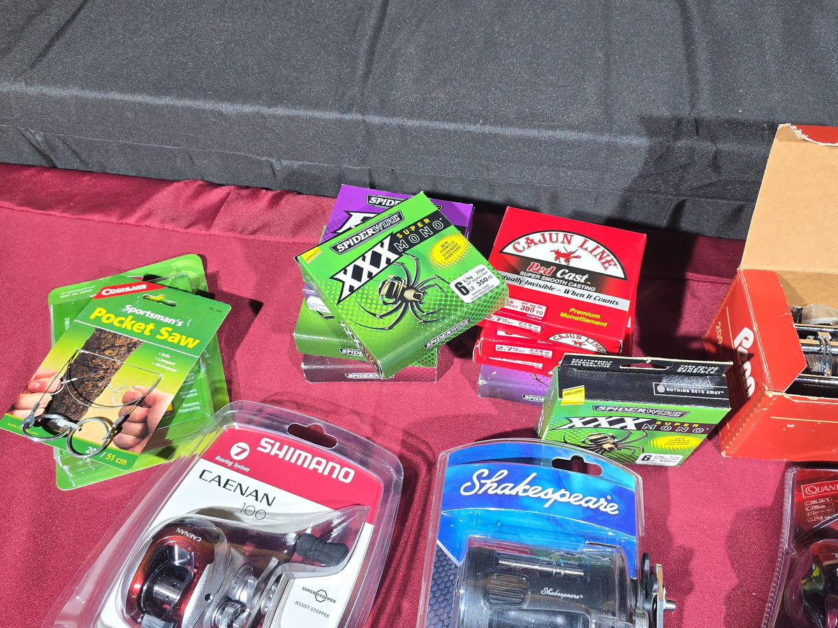 Grouping of Modern Fishing Reels, Line, and Tackle including Shimano Caenan 100, Shakespeare Tidewater, Quantum, and Penn Reels