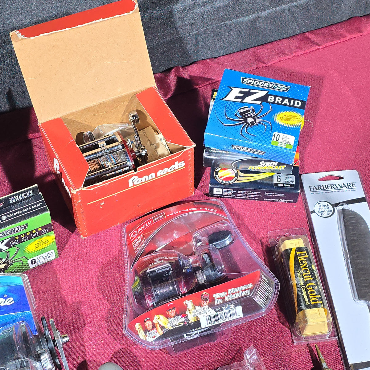 Grouping of Modern Fishing Reels, Line, and Tackle including Shimano Caenan 100, Shakespeare Tidewater, Quantum, and Penn Reels