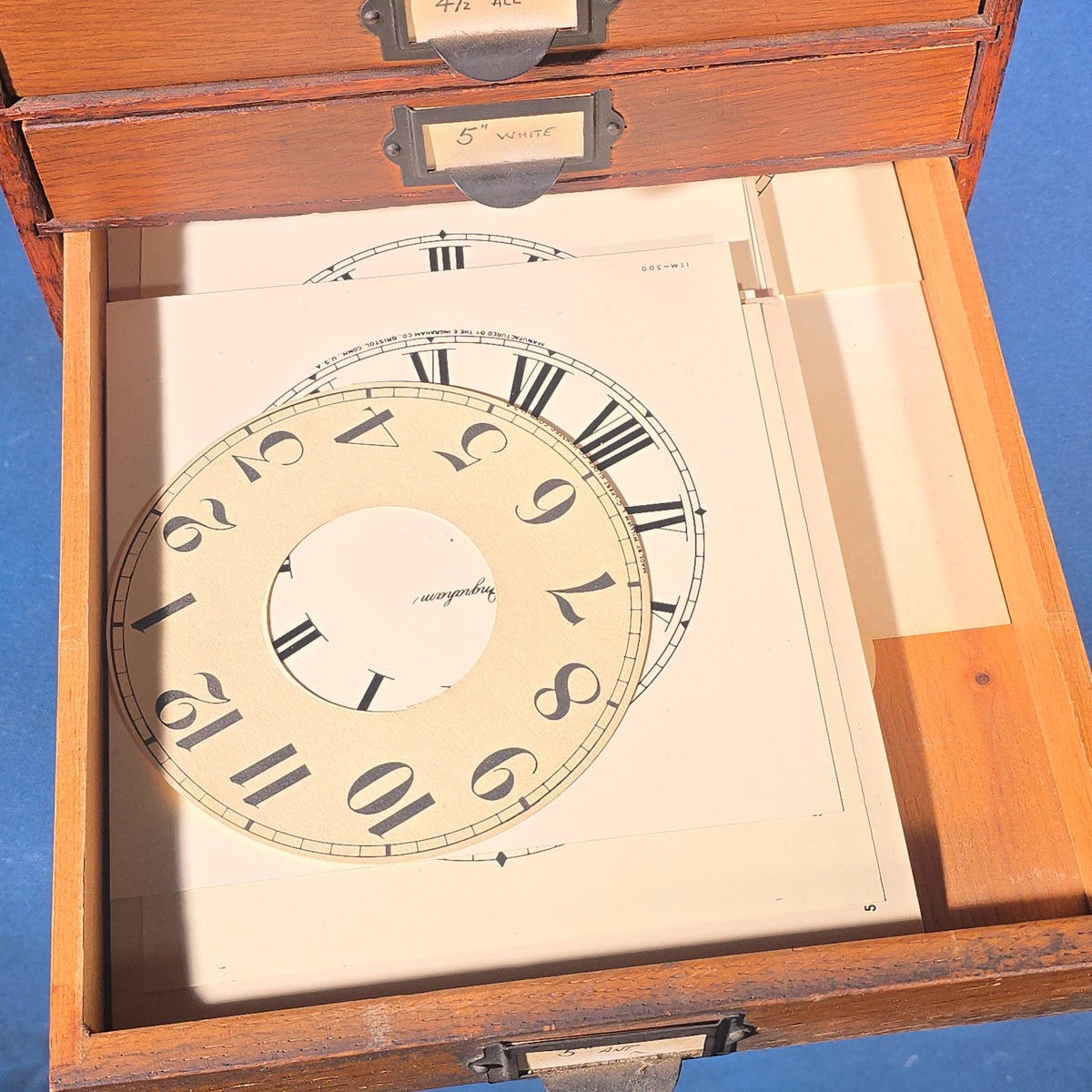 Vintage Oak Five-Drawer Cabinet with Clock Repair Paper Dial Faces including Ansonia, Sessions, and Ingraham