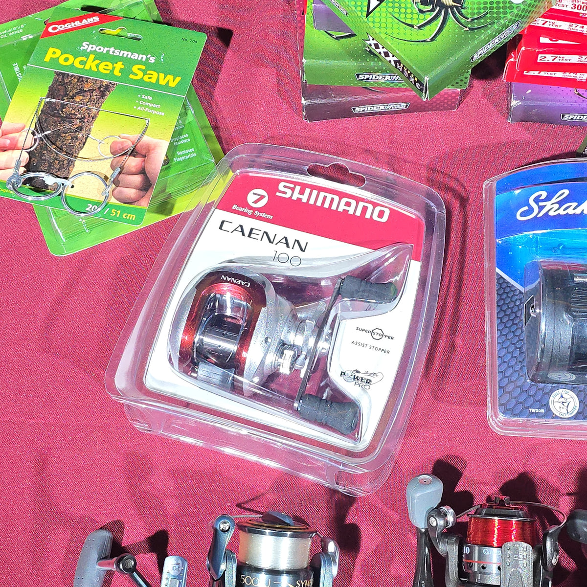 Grouping of Modern Fishing Reels, Line, and Tackle including Shimano Caenan 100, Shakespeare Tidewater, Quantum, and Penn Reels