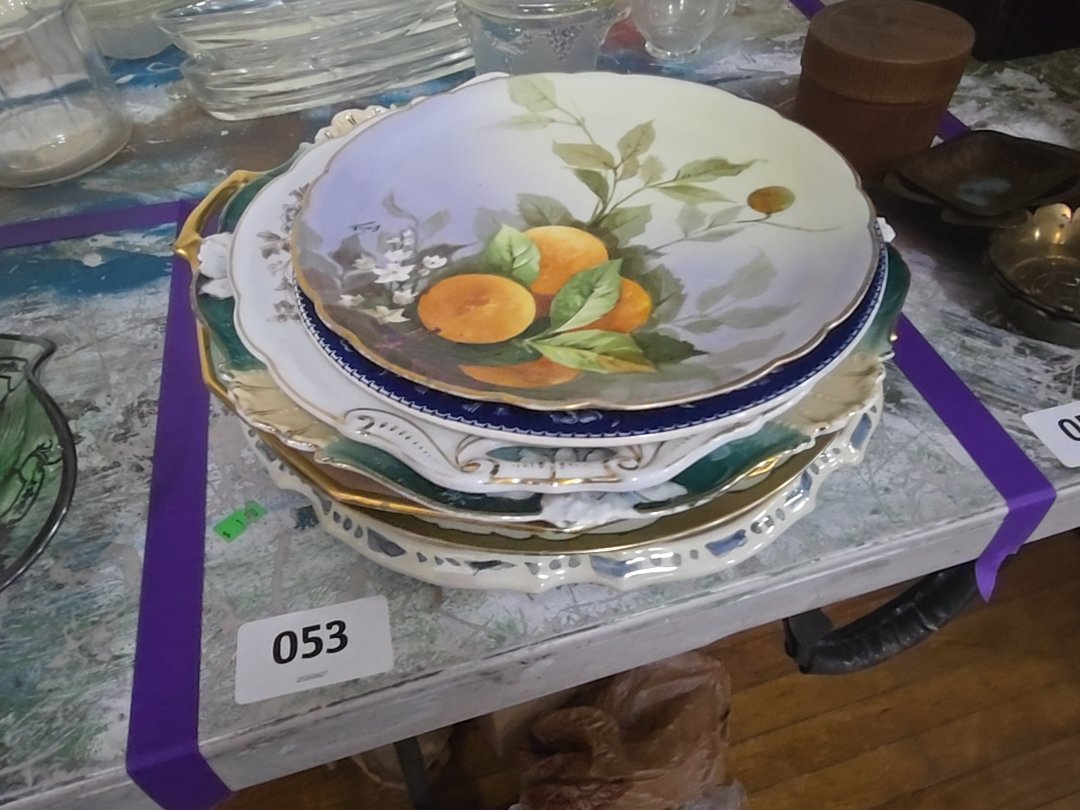 mixed grouping of various decorated China plates