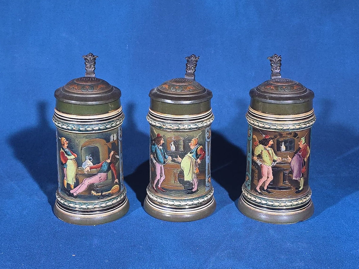Grouping of Six Antique German Pottery Steins and Lidded Pitcher with Tavern Scenes, Stamped Germany