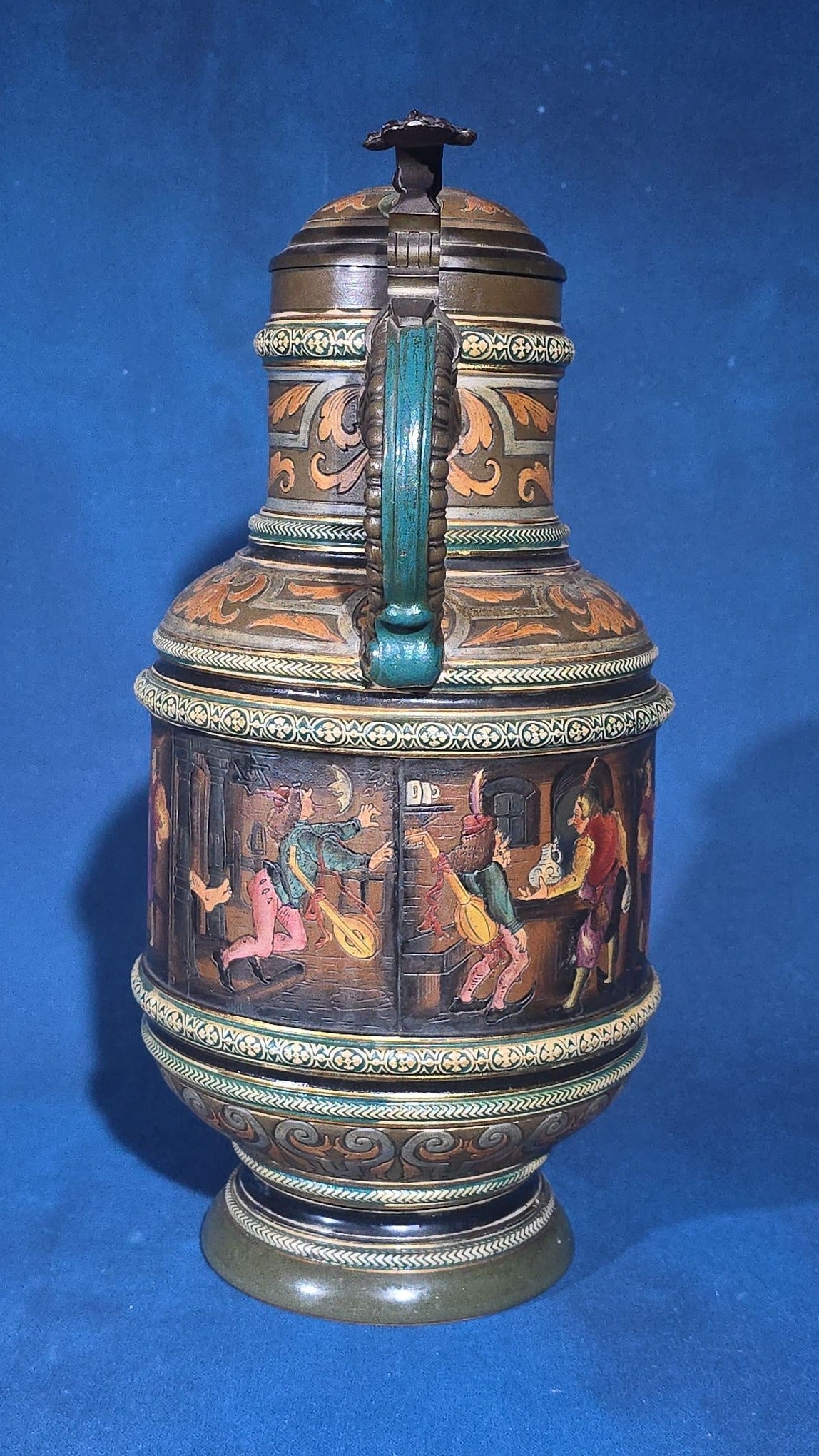 Grouping of Six Antique German Pottery Steins and Lidded Pitcher with Tavern Scenes, Stamped Germany