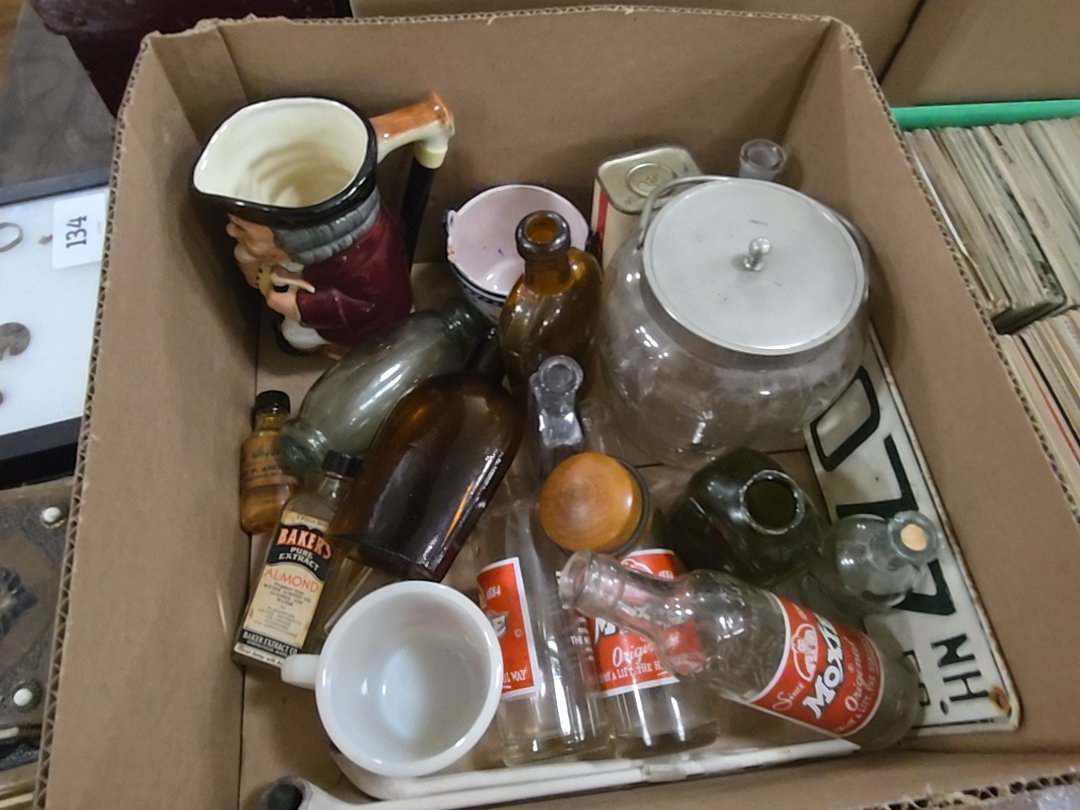 box lot of glass including Moxie bottles and New Hampshire license plate