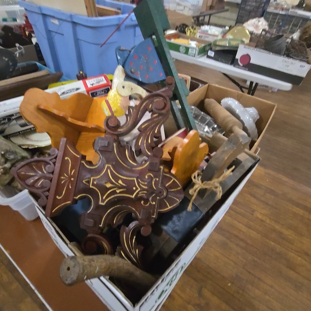 box lot of woodenware including Furniture crest, whirly gig, and more