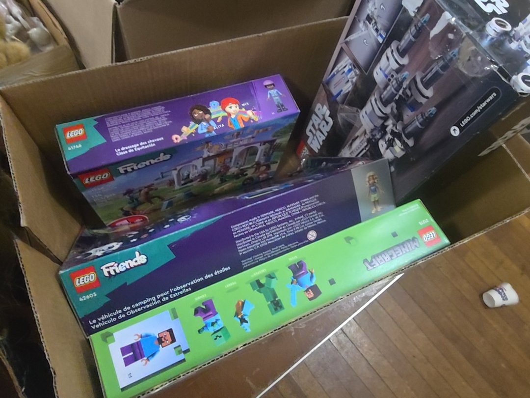 box lot with four Lego sets
