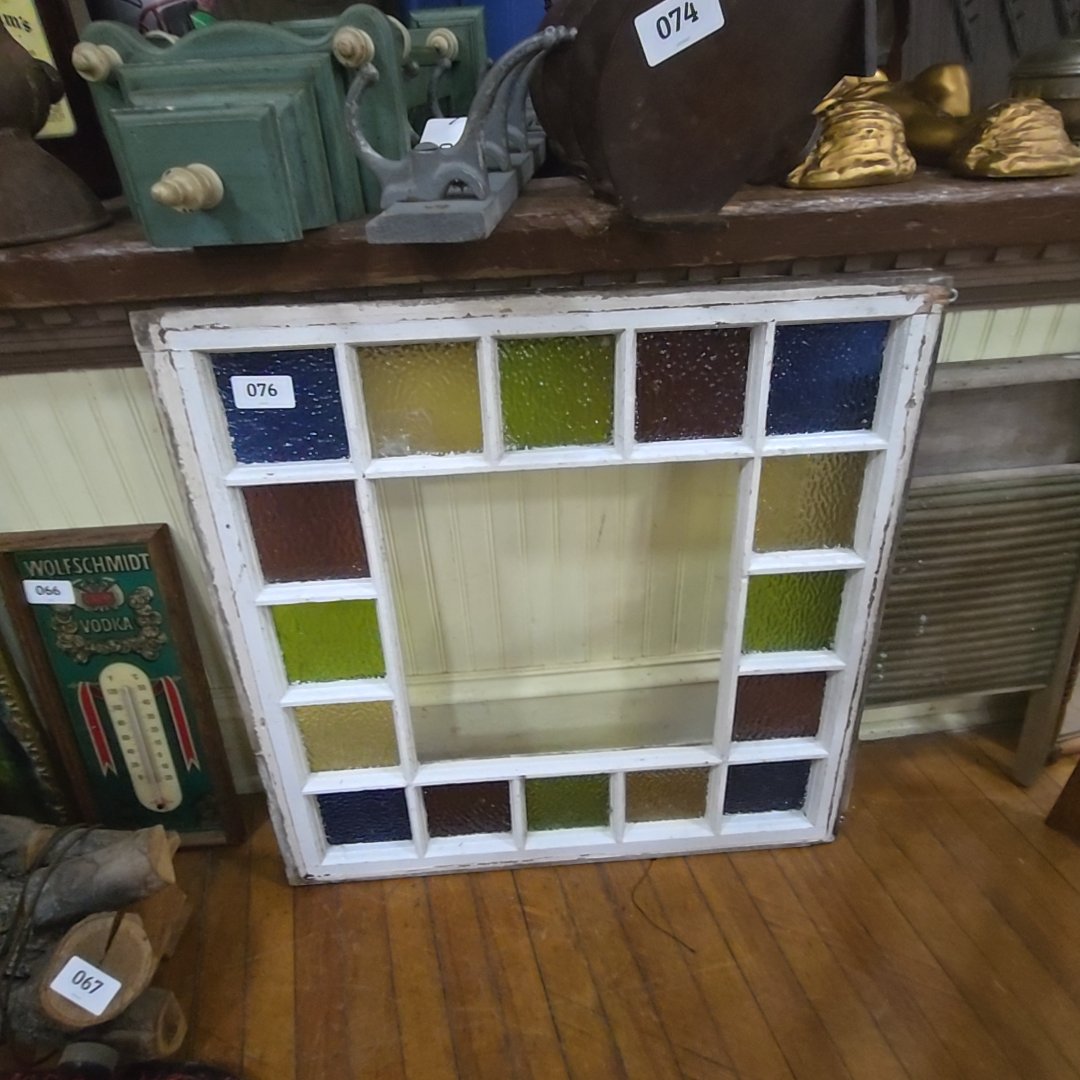 old stained glass window, has cracks and missing main panel