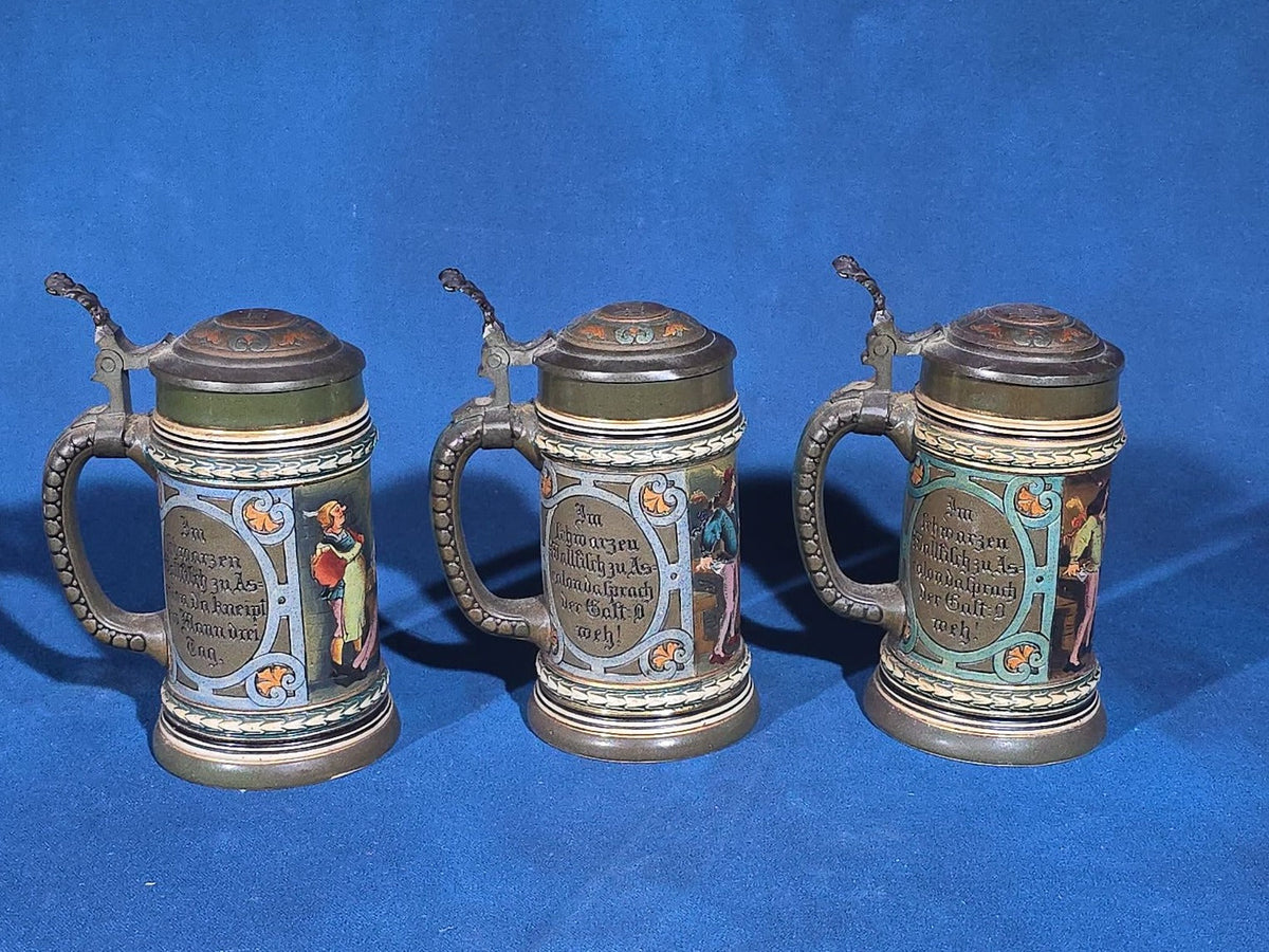 Grouping of Six Antique German Pottery Steins and Lidded Pitcher with Tavern Scenes, Stamped Germany