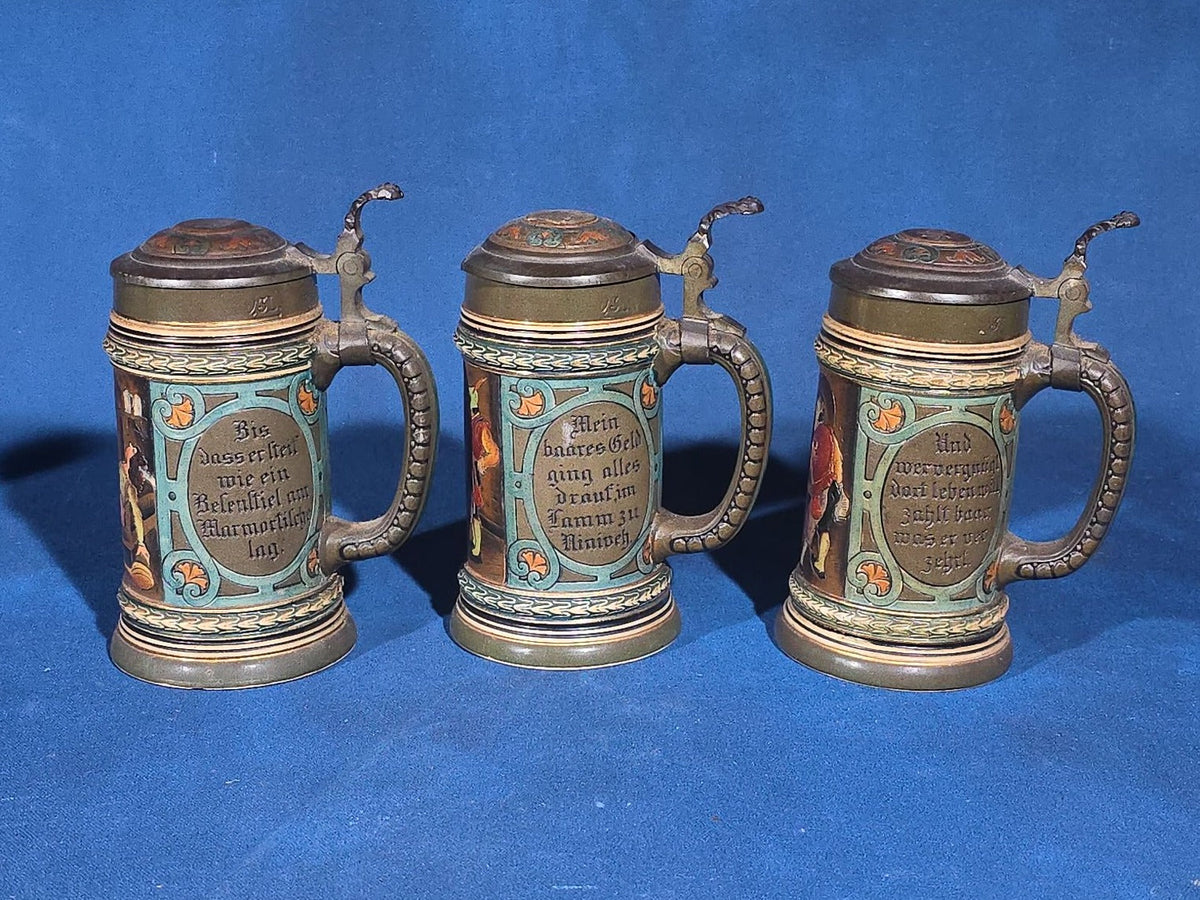 Grouping of Six Antique German Pottery Steins and Lidded Pitcher with Tavern Scenes, Stamped Germany