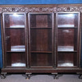 Lot 004 - Antique Carved Three-Door Glass-Front Bookcase with Green Man Masks, Rope-Twist Columns, and Claw-And-Ball Feet, 74" L x 66-3/4" H