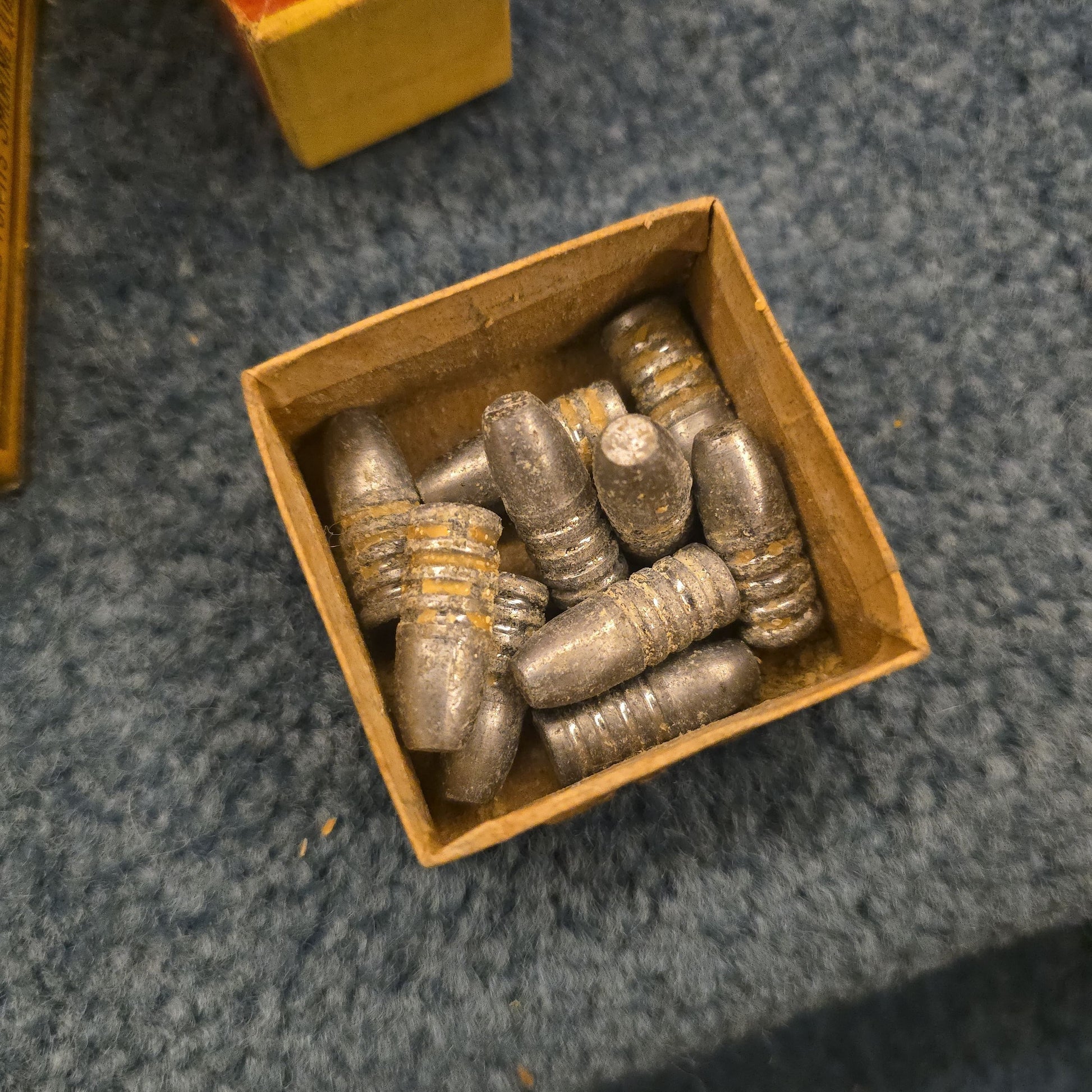 Grouping of Antique and Vintage Ammunition Boxes with Contents and Gun Accessories including Winchester .40-72 Cartridges for Model 1895, Union Metallic Cartridge Co. Ballard & Bullard Bullets, and Colt Grip Panel