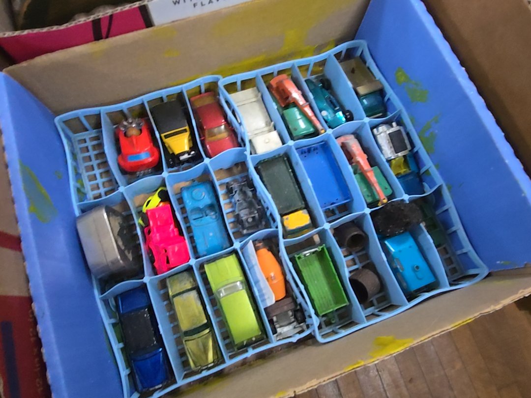box lot of toy cars including red lines