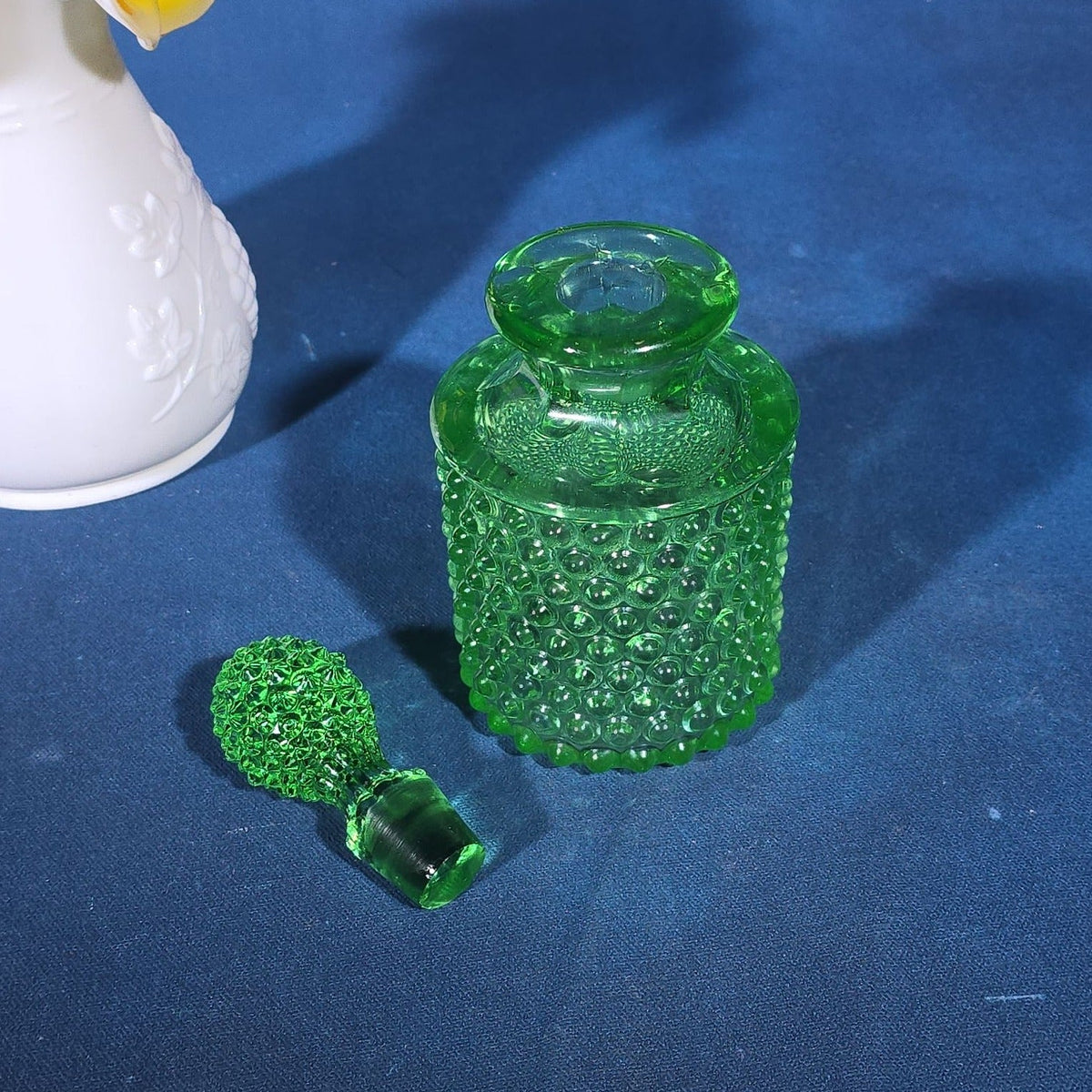 Pair of Vintage Art Glass Pieces including White Cased Glass Vase with Yellow Ruffled Rim and Green Hobnail Glass Decanter with Stopper