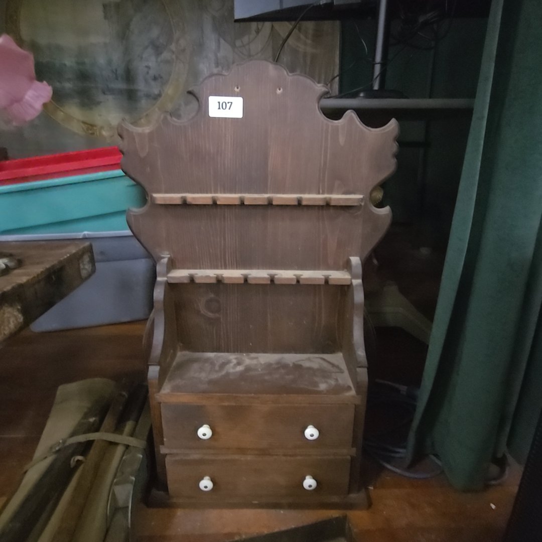 vintage wall spoon rack with contents in drawers