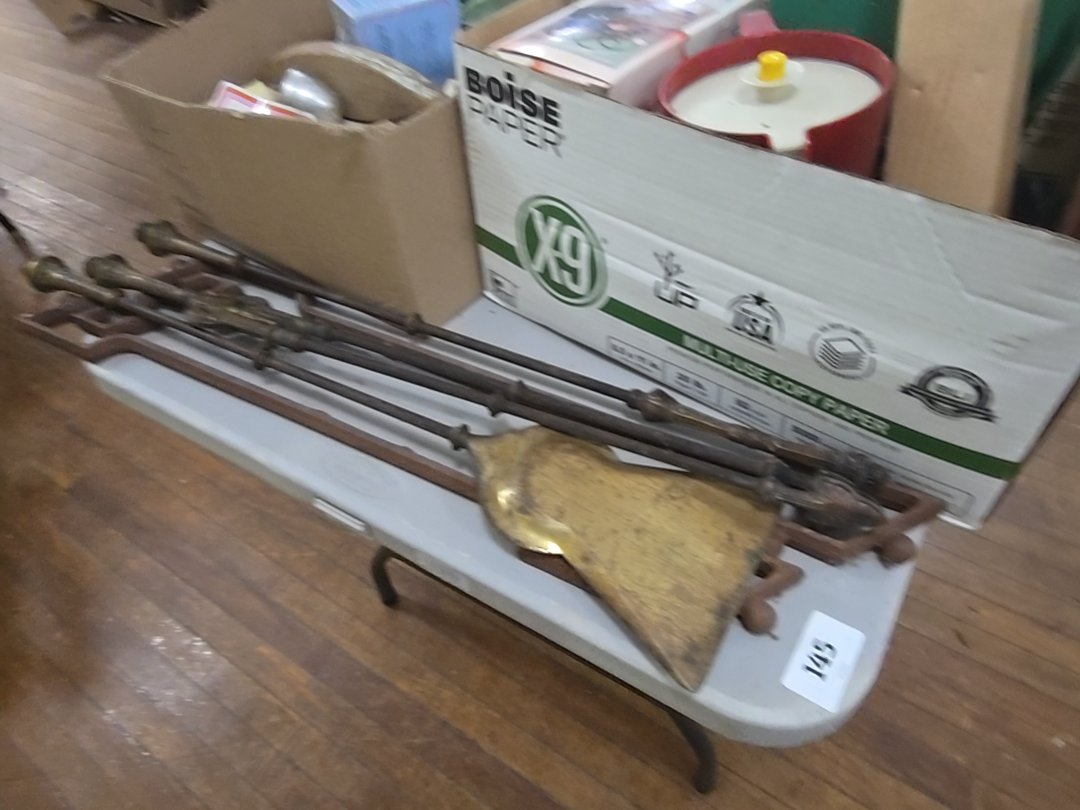 table lot with fire tools and cast iron piece