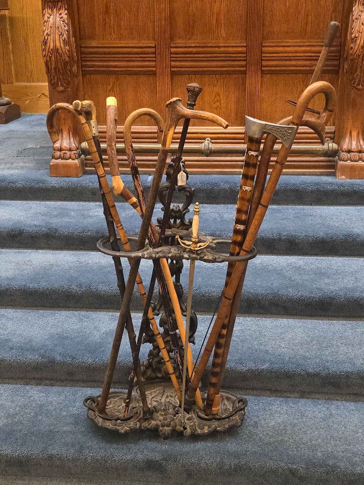 Antique Cast Iron Figural Cane Stand with a Collection of Antique and Vintage Walking Canes and Swords