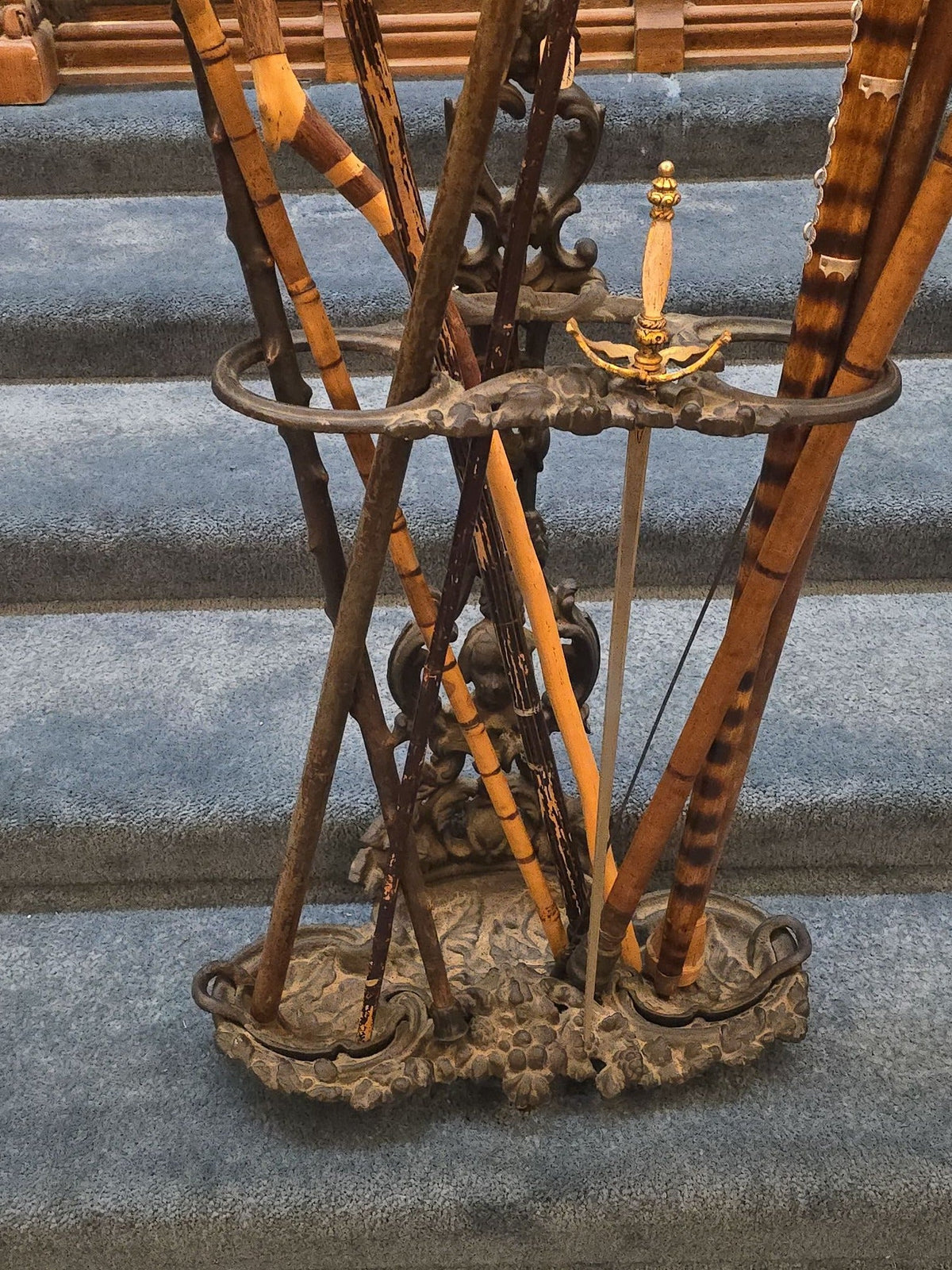 Antique Cast Iron Figural Cane Stand with a Collection of Antique and Vintage Walking Canes and Swords