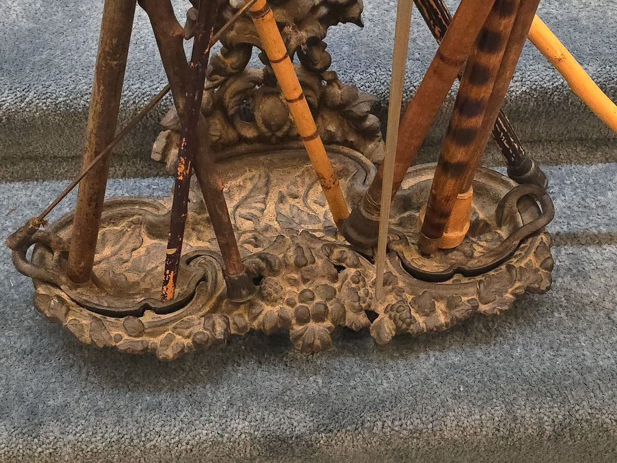 Antique Cast Iron Figural Cane Stand with a Collection of Antique and Vintage Walking Canes and Swords