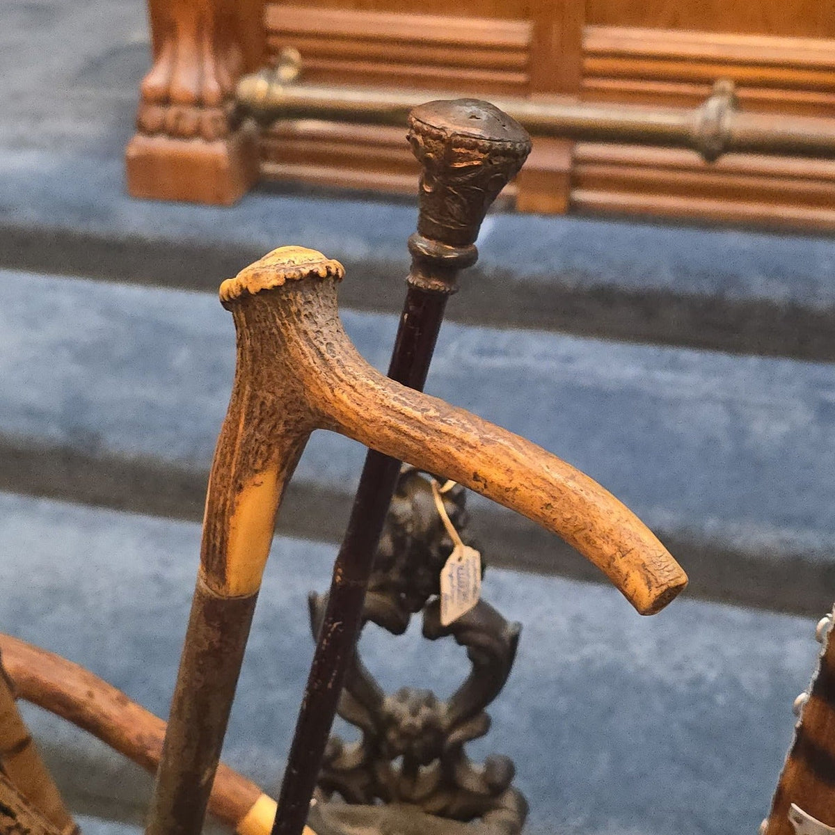 Antique Cast Iron Figural Cane Stand with a Collection of Antique and Vintage Walking Canes and Swords