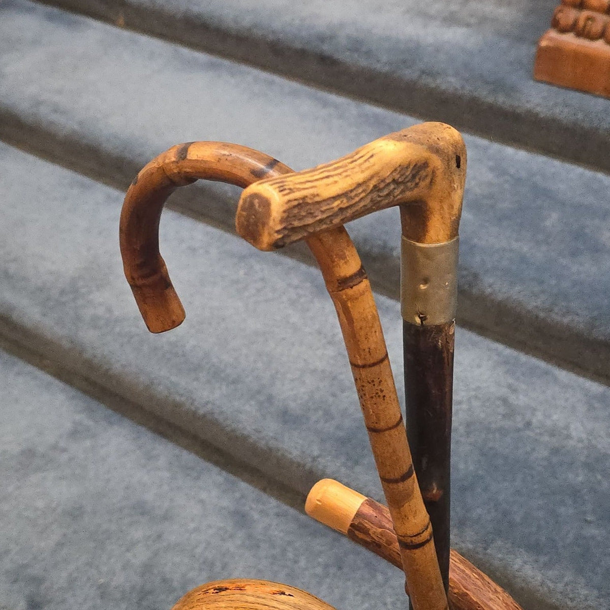 Antique Cast Iron Figural Cane Stand with a Collection of Antique and Vintage Walking Canes and Swords