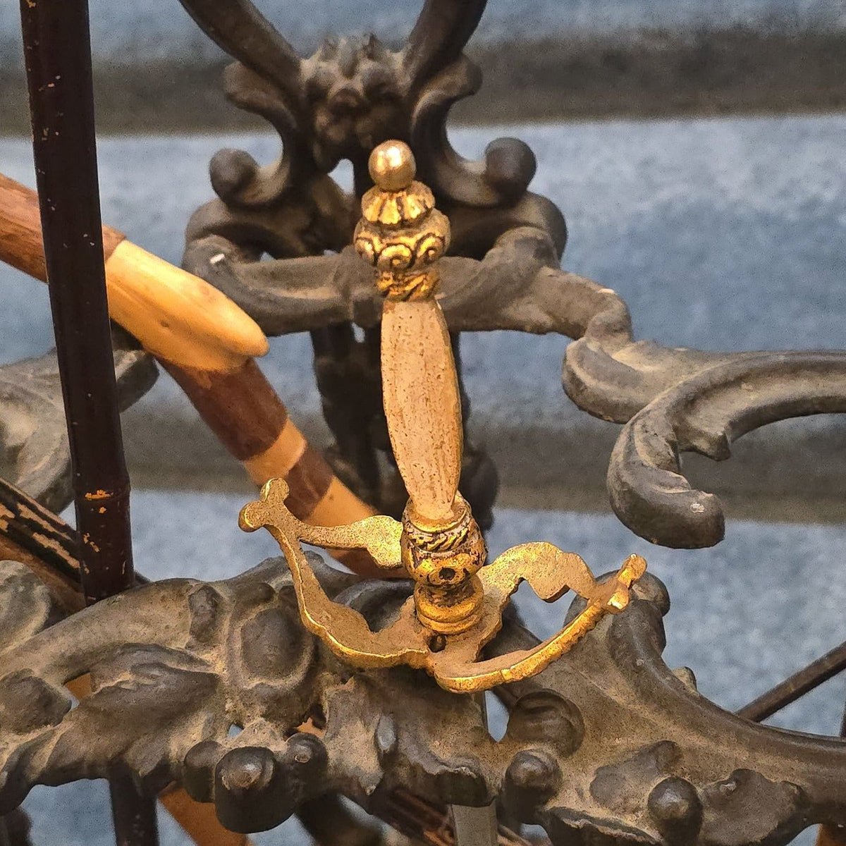 Antique Cast Iron Figural Cane Stand with a Collection of Antique and Vintage Walking Canes and Swords