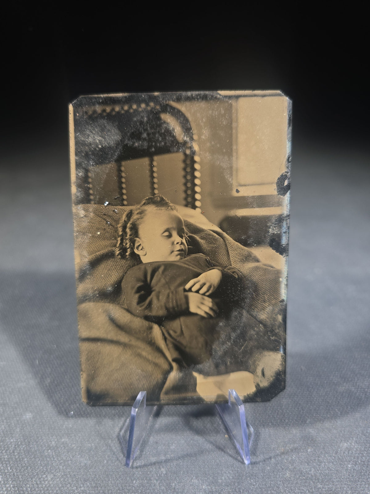 Antique Tintype Photograph of a Young Child Reclined on a Pillow, Likely Postmortem