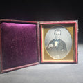 Lot 010 - Antique 1/6th Plate Daguerreotype Photograph of a Young Man Wearing a Plaid Vest and Bow Tie in Full Leatherette Case
