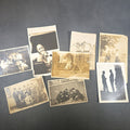 Lot 028 - Grouping of Eight Antique and Vintage Snapshot Photographs Including Boys Gambling on a Sidewalk, Clown on Stoop, Silhouette of Two Figures on a Shore, and a Group Portrait Outside