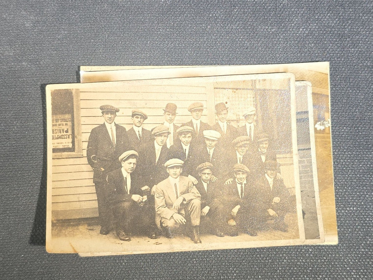 Grouping of Eight Antique and Vintage Snapshot Photographs including Boys Gambling on a Sidewalk, Clown on Stoop, Silhouette of Two Figures on a Shore, and a Group Portrait Outside