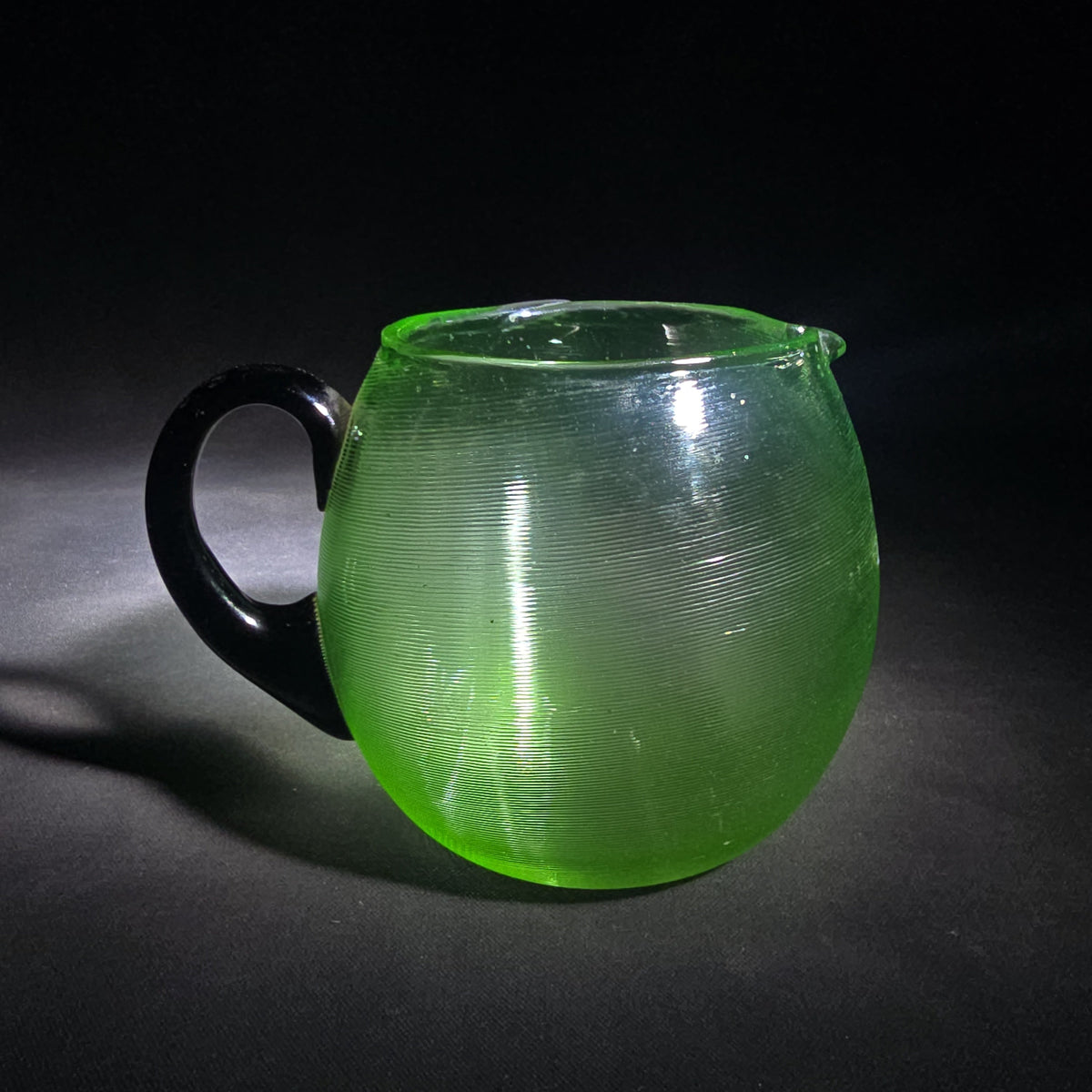 Vintage Hand-Blown Green Uranium Glass Pitcher with Applied Black Handle, UV Reactive
