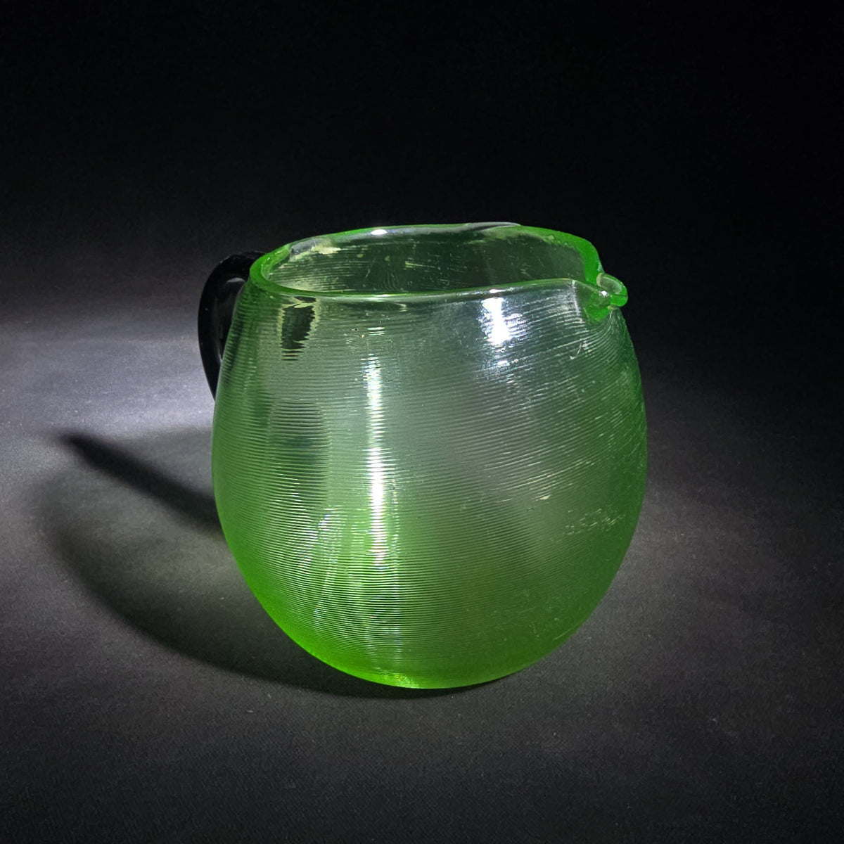 Vintage Hand-Blown Green Uranium Glass Pitcher with Applied Black Handle, UV Reactive