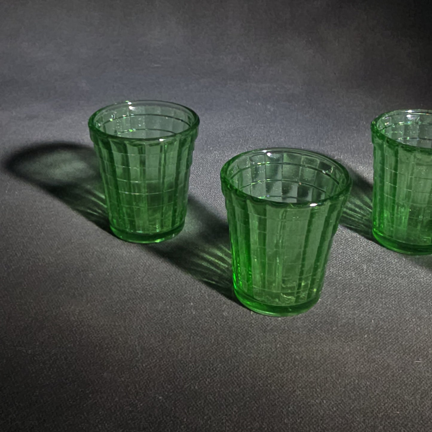Grouping of Six Vintage Green Uranium Glass Shot Glasses with Paneled Grid Pattern, UV Reactive