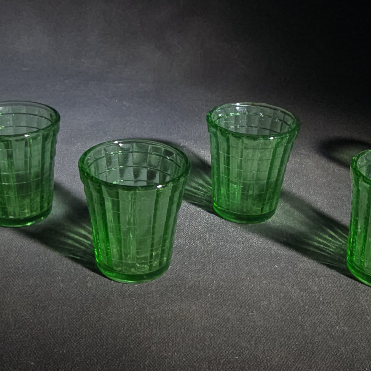 Grouping of Six Vintage Green Uranium Glass Shot Glasses with Paneled Grid Pattern, UV Reactive
