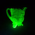 Lot 065 - Antique Uranium Glass Pressed Creamer with Medallion and Ribbed Pattern, Floral Scalloped Rim, UV Reactive, Note Crack on Bottom, 5" H