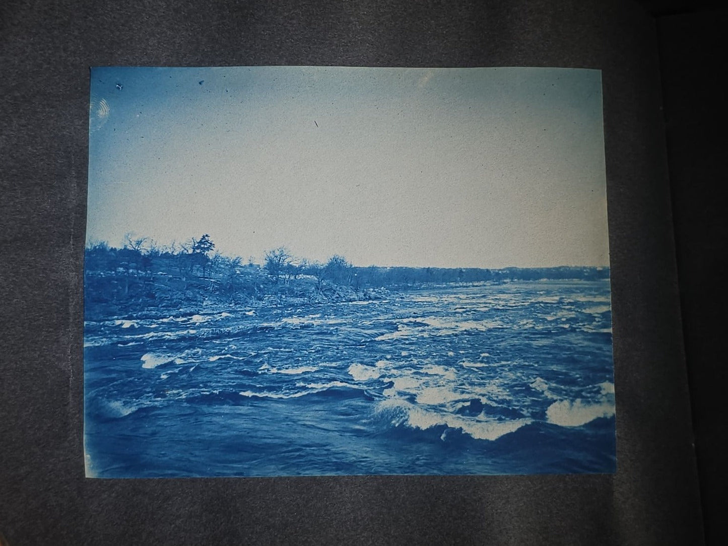 Antique Cyanotype Photo Album Containing Nine Cyanotype Photographs Including Comic Scene with Cow, Colonial House, River Rapids, Park Pond, and Orchard Landscape