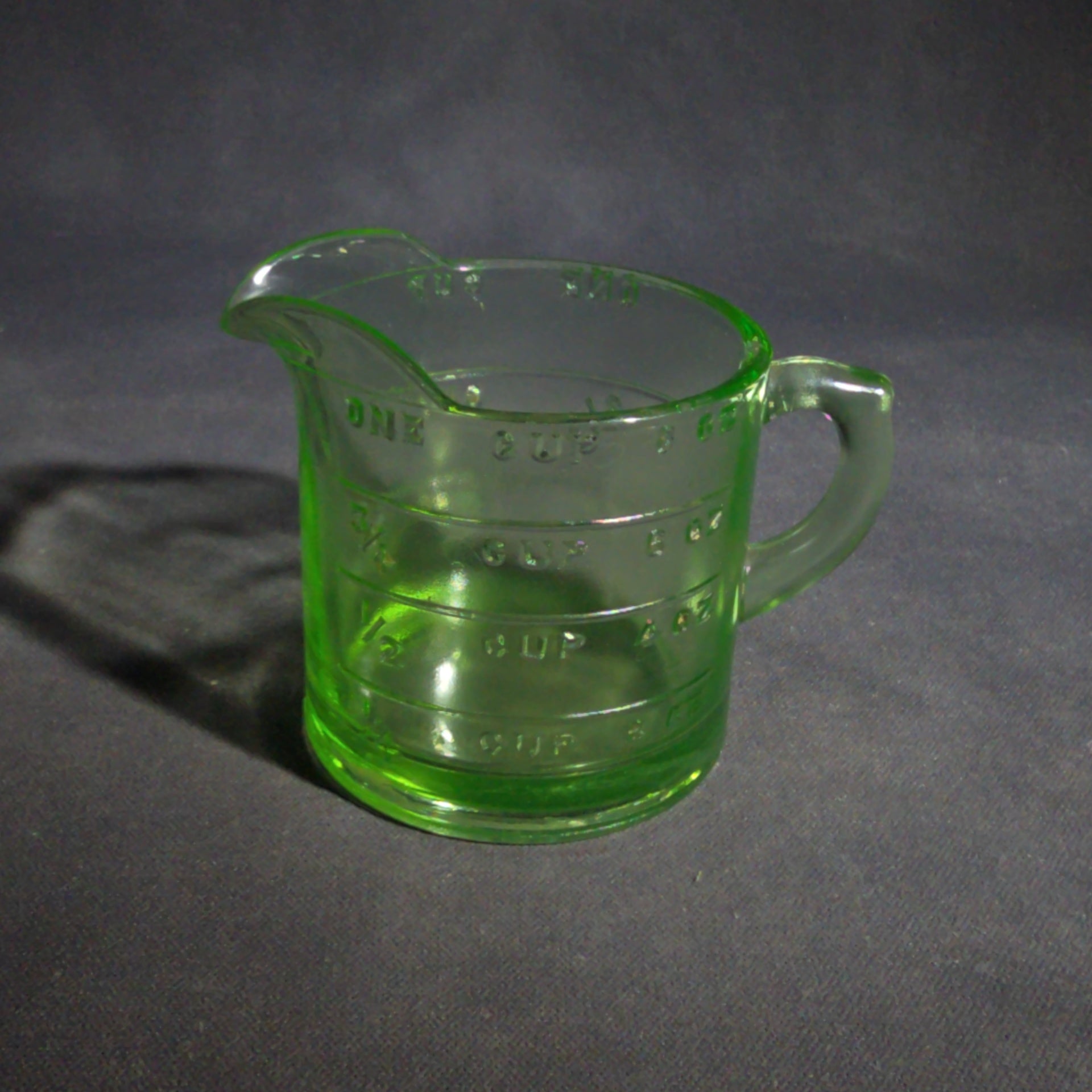 Antique Uranium Glass Spout Measuring Cup with Embossed Graduated Markings, UV Reactive