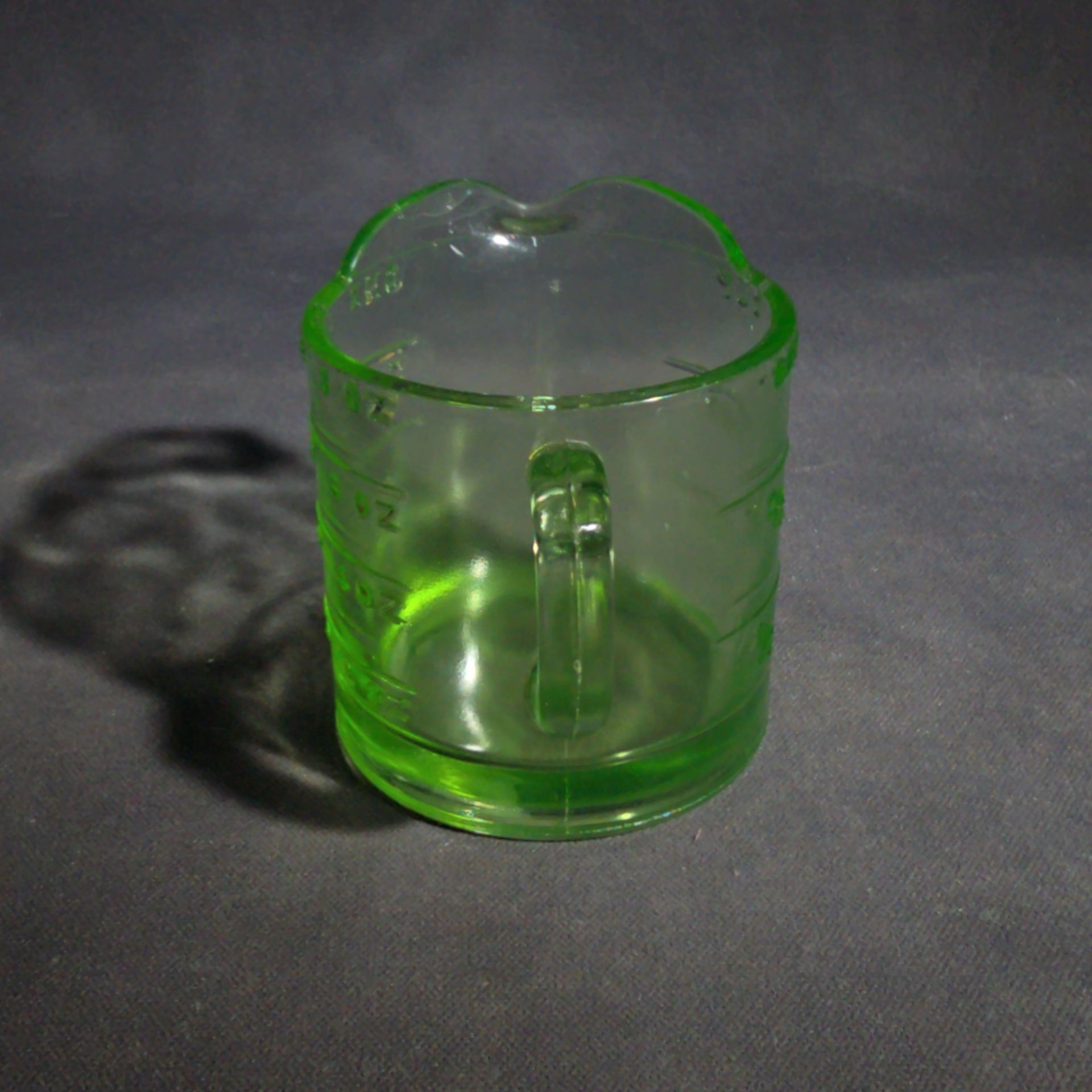 Antique Uranium Glass Spout Measuring Cup with Embossed Graduated Markings, UV Reactive
