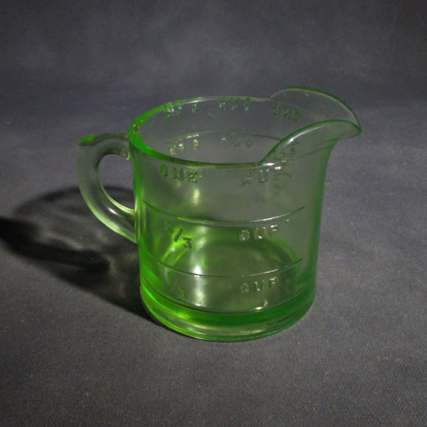 Antique Uranium Glass Spout Measuring Cup with Embossed Graduated Markings, UV Reactive