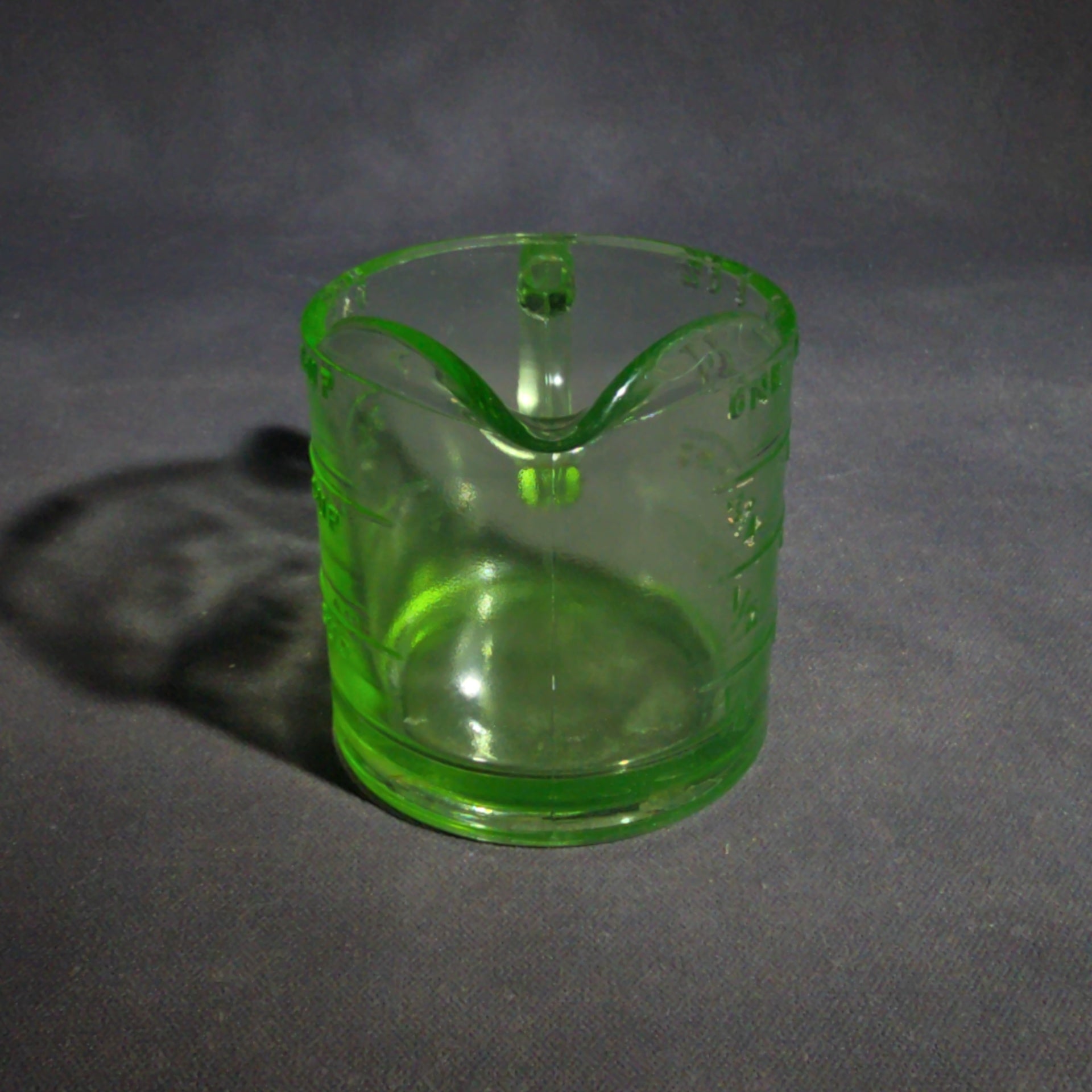 Antique Uranium Glass Spout Measuring Cup with Embossed Graduated Markings, UV Reactive