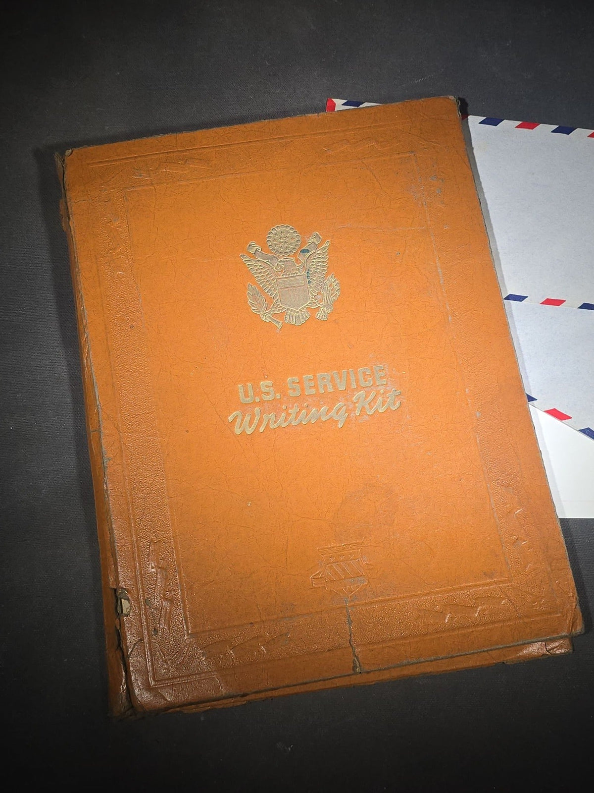 Vintage WWII U.S. Service Writing Kit with Contents including "Armoreader" Camp Polk, Louisiana Newsletter, "The Communique" Newsletter, Chemical Warfare Pocket Reference Card, and Die-Cut Kewpie Christmas Ornaments